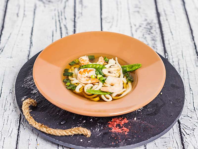 Hawaiian Saimin Soup In terracotta bowl on table