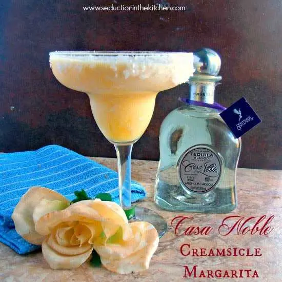 Casa Noble Creamsicle Margarita brown backround with rose