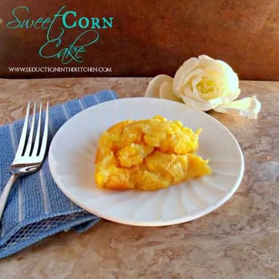 Sweet Corn Cake on white plate with fork and rose