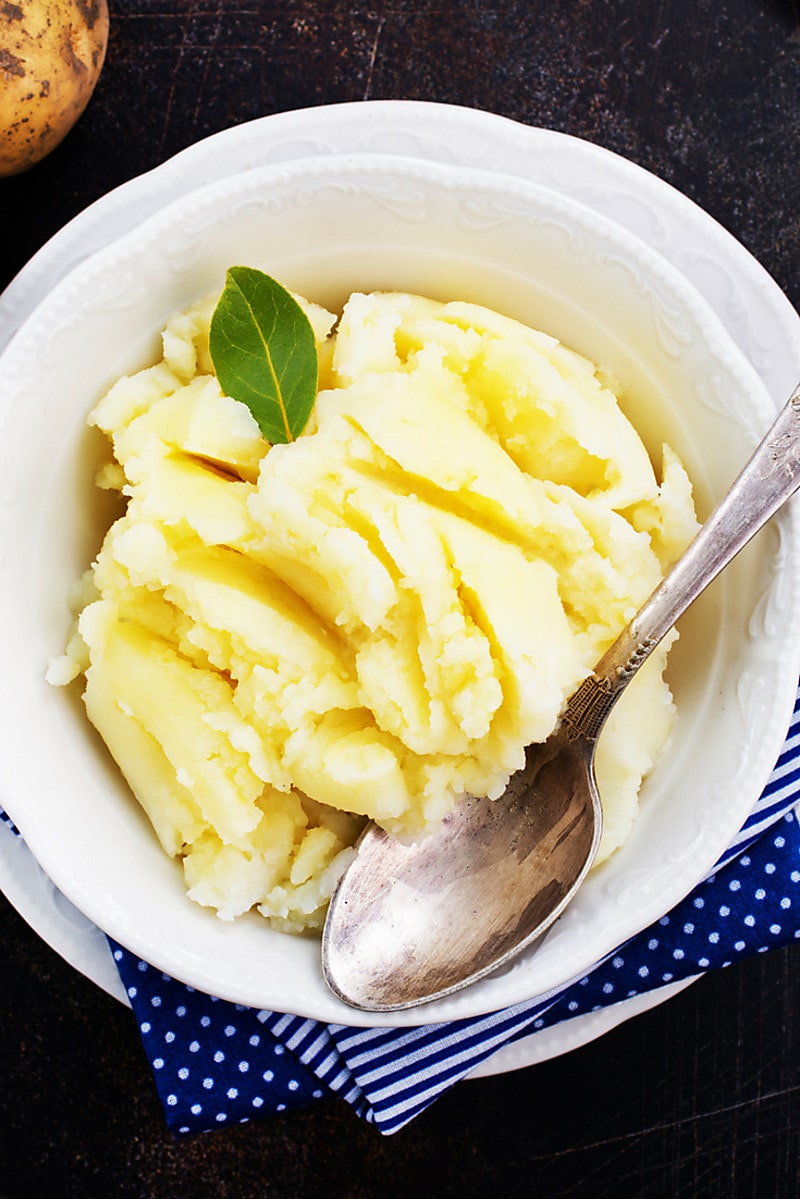 Ricotta Mashed Potatoes close up in white bowl with spoon