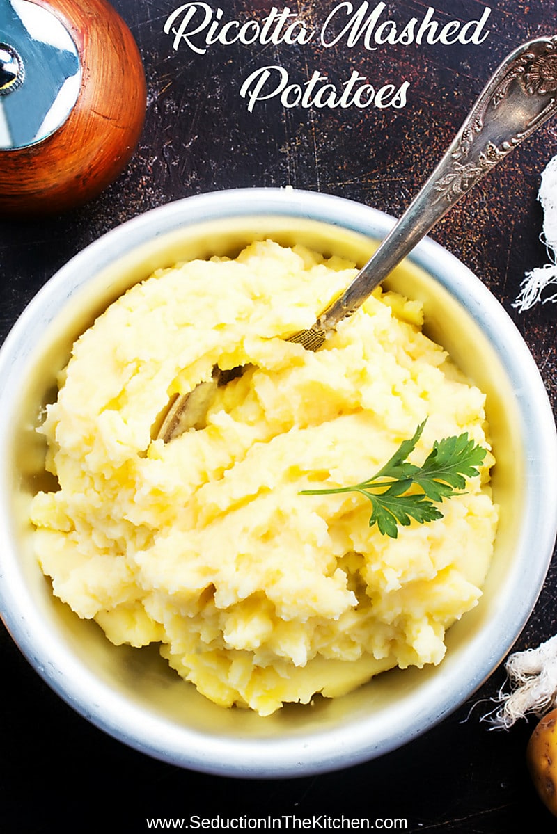 Ricotta Mashed Potatoes In a white bowl on table with spoon title shot