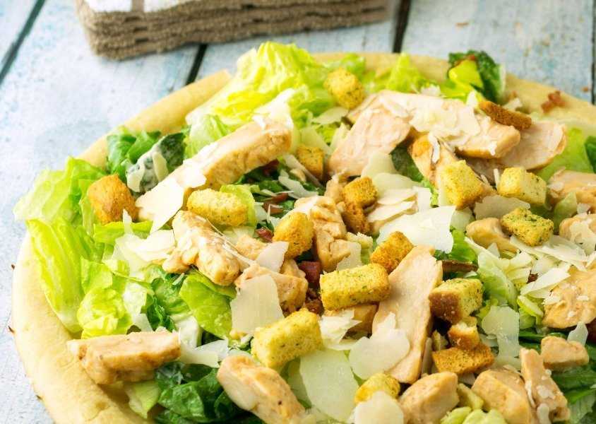 Bacon Chicken Caesar Salad Pizza is inspired by Caesar's Palace Resort in Las Vegas. It is Caesar salad meets pizza with grilled chicken and bacon toppings.