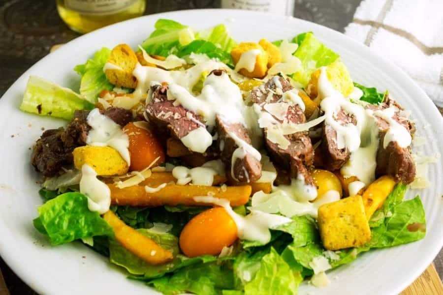 Pittsburgh Steak Salad is unique in the way the people of Pittsburgh Pa eat the steak salad by adding fries and Ranch dressing to it.