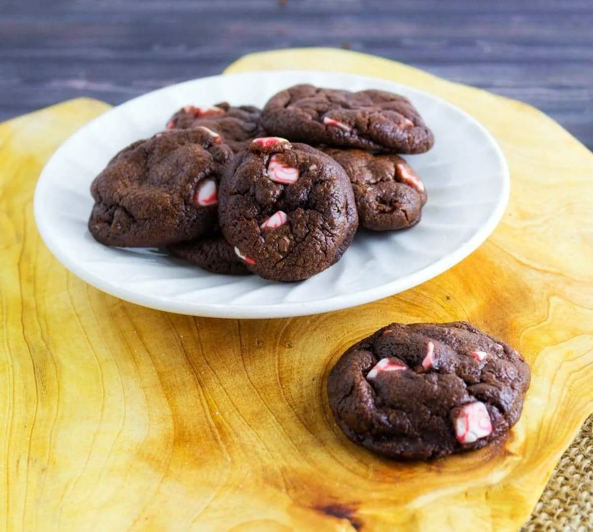 Dark Chocolate Peppermint Crunch Cookies on white plate on wood cutting board