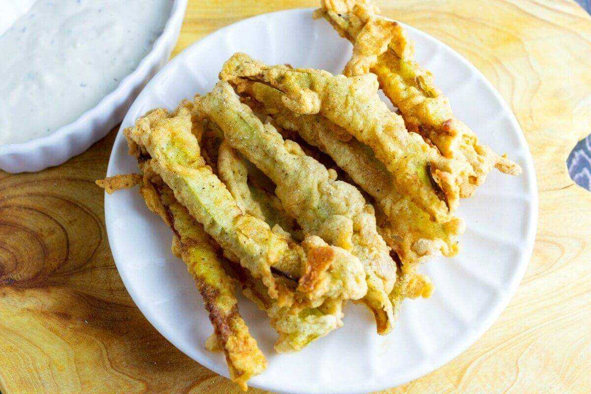 Dill Pickle Fries is simply a dill pickle that been cut into thin strips, battered, and deep fried. Inspired by a side dish at a restaurant in Cleveland Ohio, and now you can make them at home. A recipe from Seduction in the Kitchen.