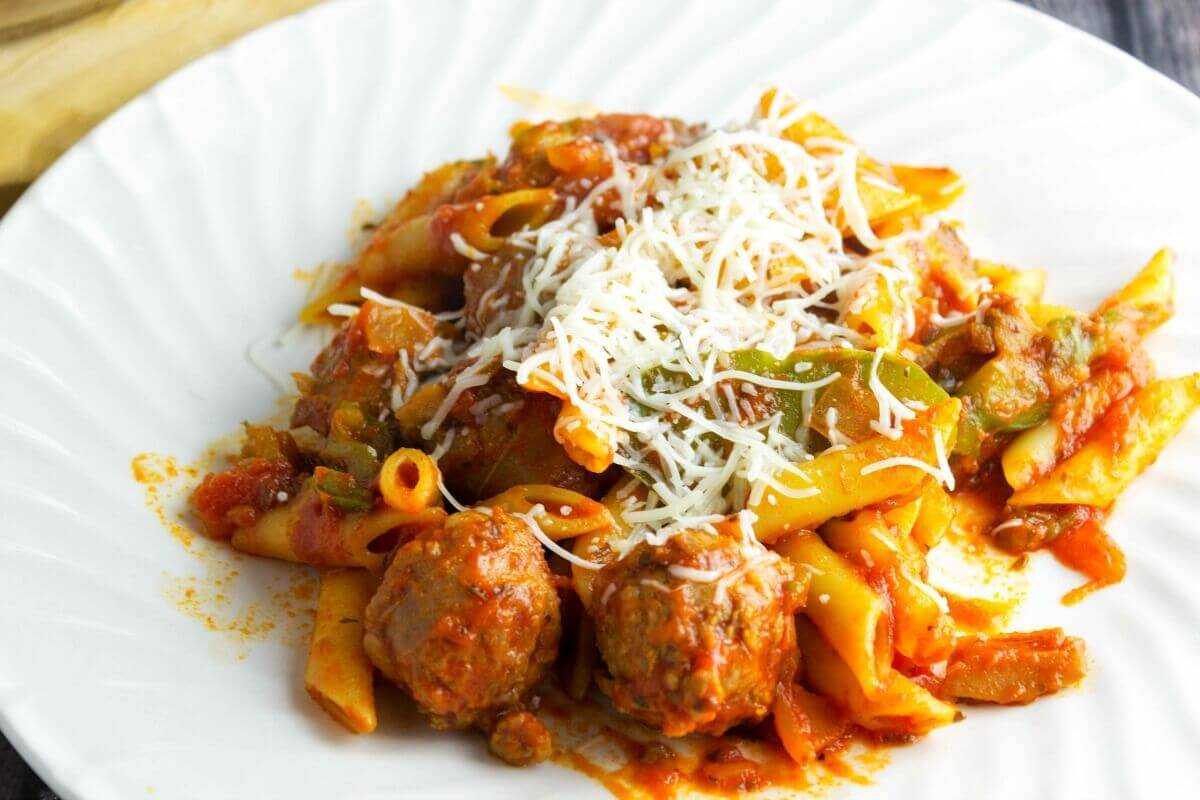 Sausage and Peppers Mostaccioli on closeup on white plate