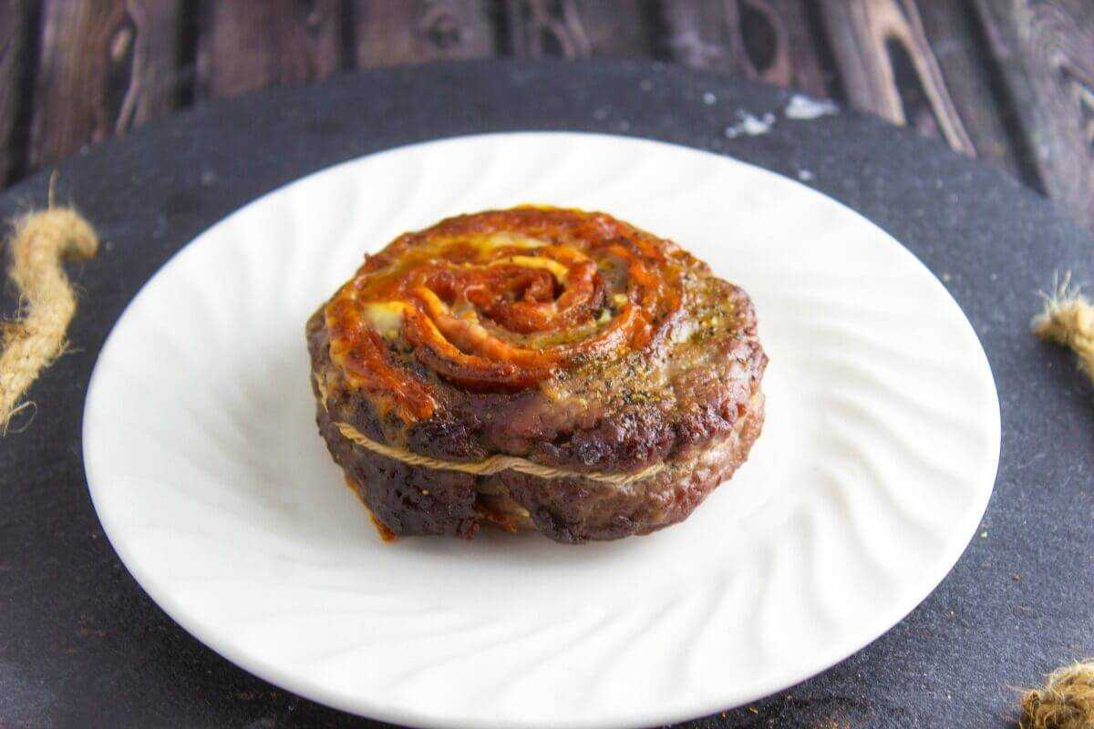 Spicy Italian Stuffed Eye of Round on plate on a table