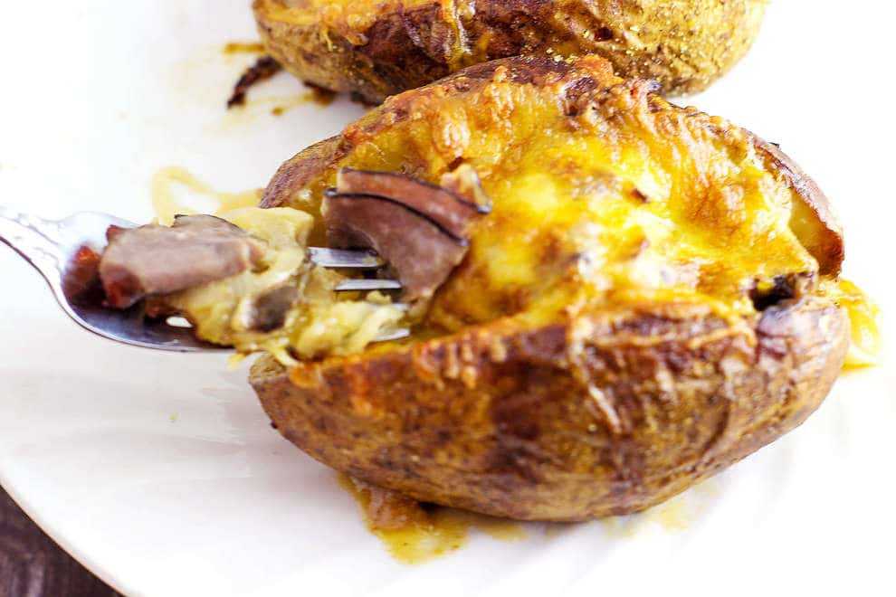 Roast Beef Stuffed Baked Potatoes is a meal in itself. Tender roast beef with caramelized onions and au jus gravy stuffed into a potato than covered with melted cheese. This recipe is a good way to use up leftover roast beef. 