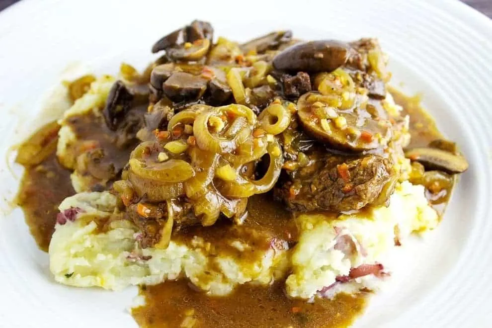 Mushroom and Onion Smothered Cube Steak is easy to make and is perfect for a weekend dinner. Tender cube steak smothered with a gravy, mushrooms, and onions on top of mashed potatoes. 