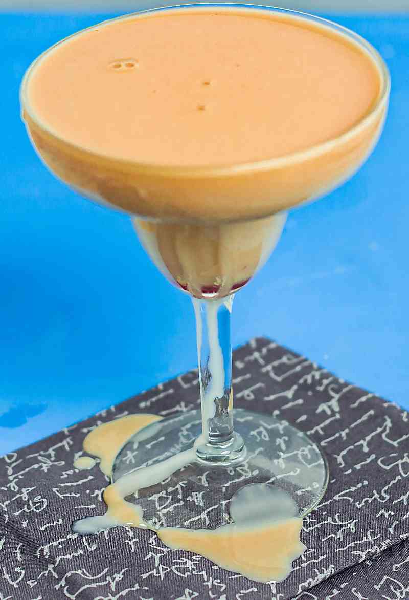 Creamsicle margarita on grey printed napkin on blue background