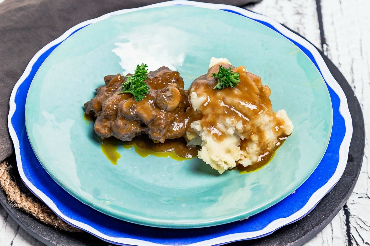 Slow Cooker Salisbury Steak wide view on plate