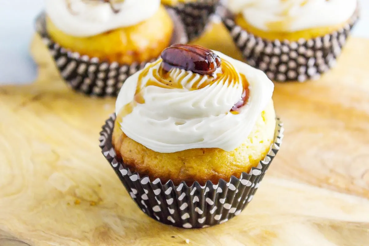 Maple Bacon Bourbon Pecan Cupcakes a sweet treat you can have for breakfast! Maple cream cheese icing adorn a delicious bacon filled cupcakes