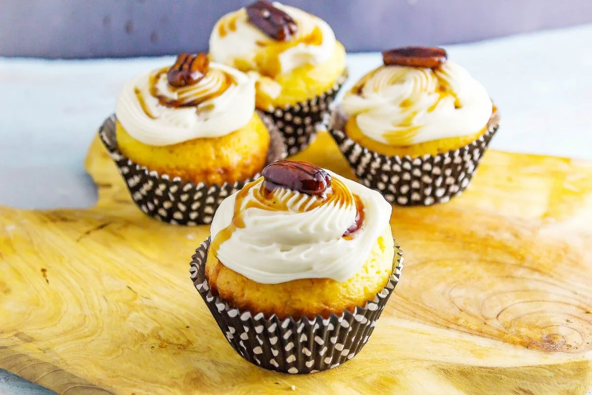 Maple Bacon Bourbon Pecan Cupcakes a sweet treat you can have for breakfast! Maple cream cheese icing adorn a delicious bacon filled cupcakes