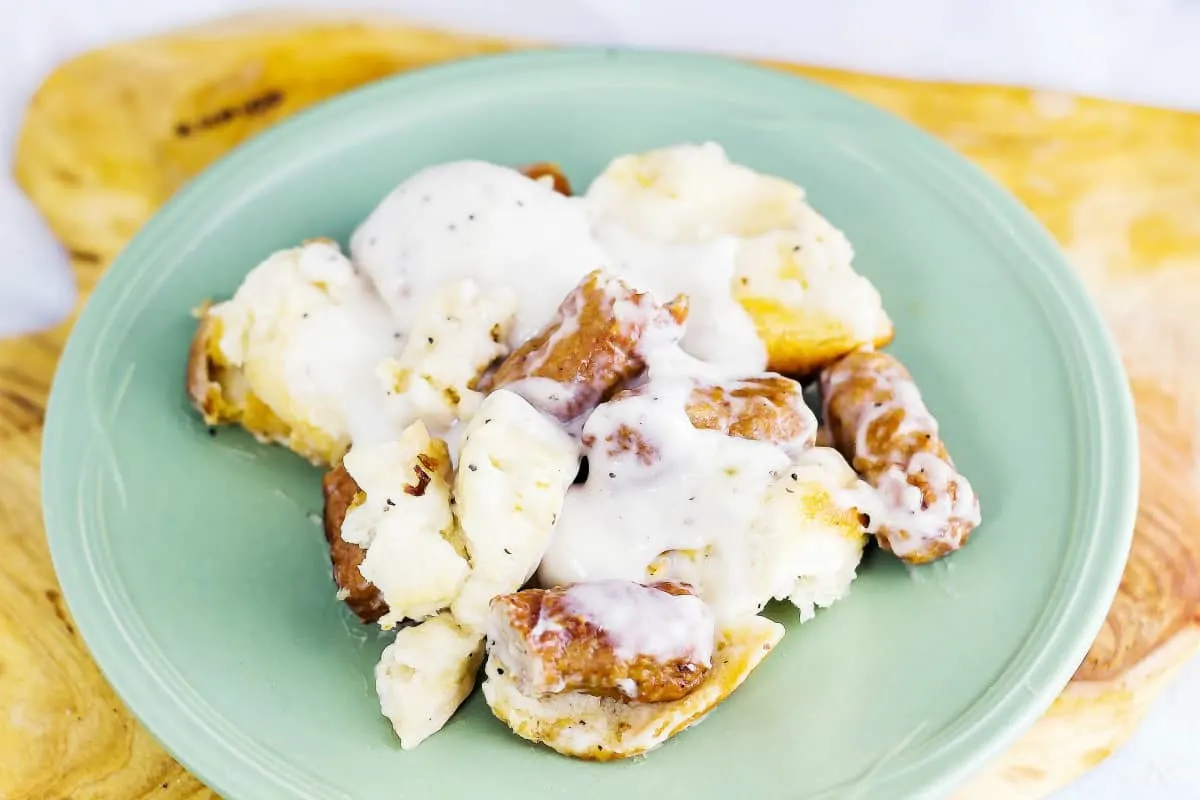 Grandma's Biscuits and Gravy Casserole is flaky, buttery biscuits drenched in a creamy sauce with sausage all baked up in a casserole.