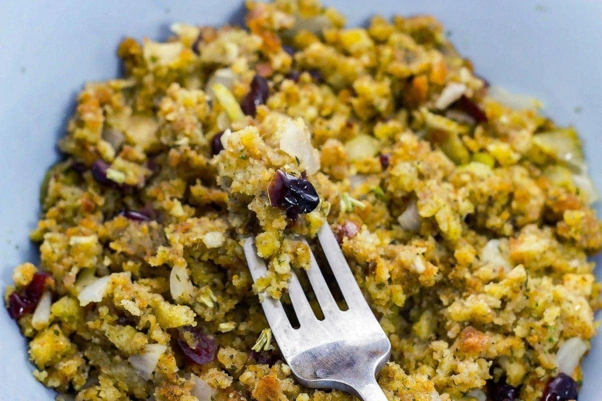 Cranberry Walnut Stuffing is a flavorful stuffing that you can make for the holidays. This savory side dish will sure to please everyone. fork view