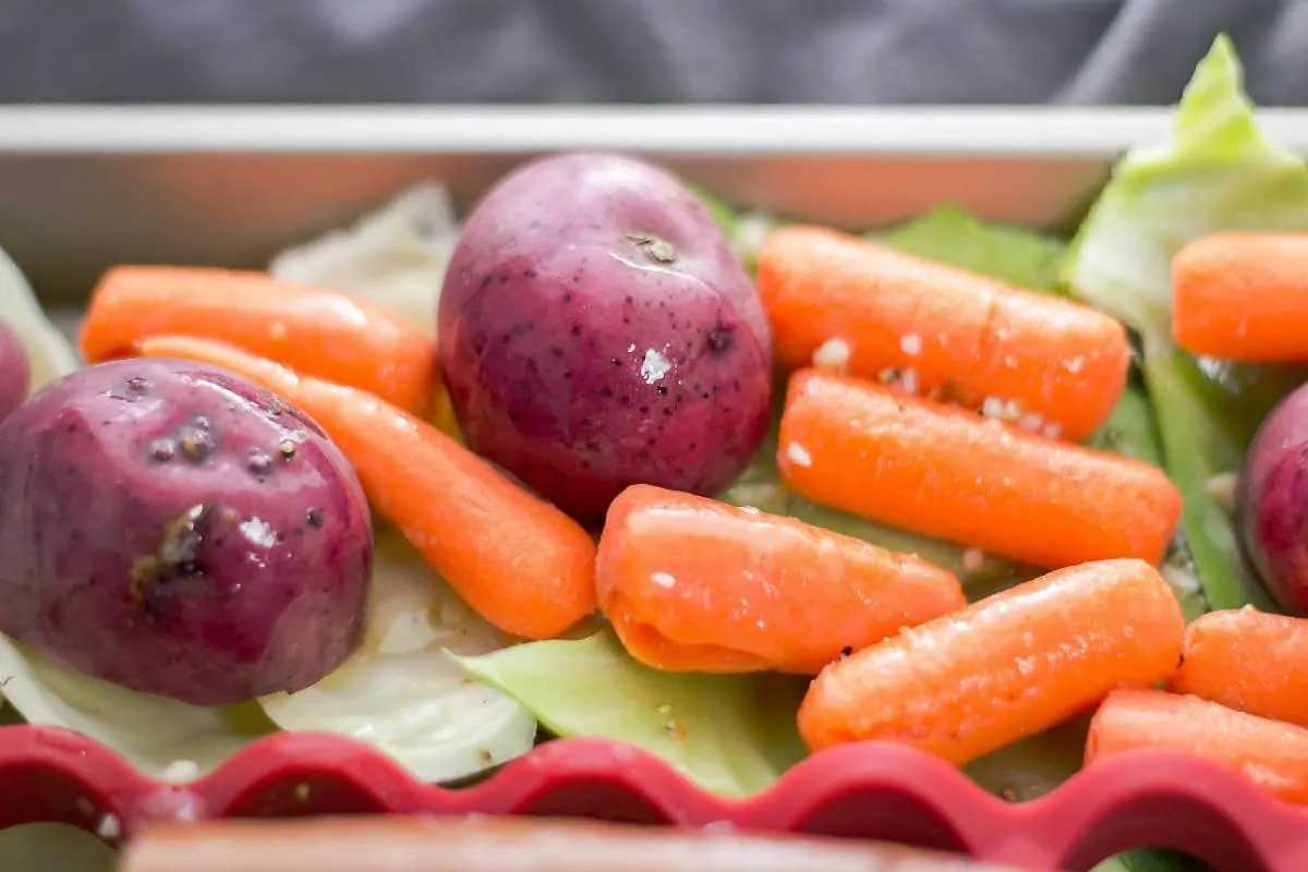 Sheet Pan Kielbasa and Cabbage uses OXO's sheet pan and silicone baking rack to create an easy buttery dinner that a family would enjoy! potatoes and carrot with sauce