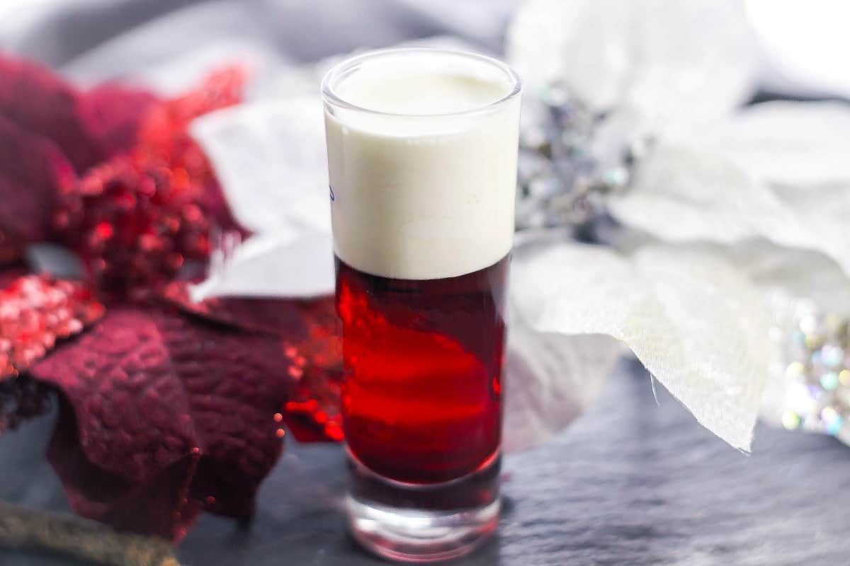 Santa Panties drink on table with red and white poinsettia