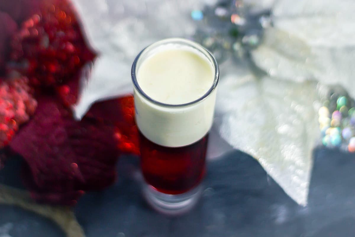 Santa Panties drink on table with red and white poinsettia top view 