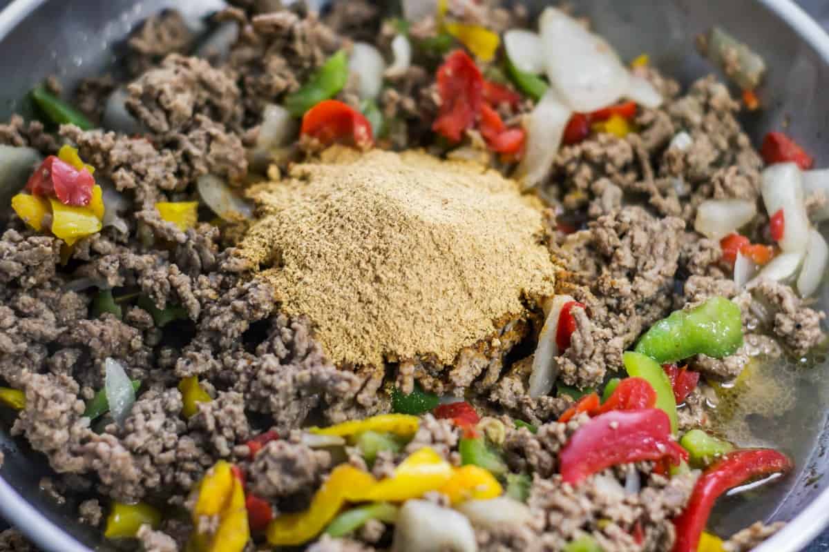 Seasoning the filling for taco pot pie