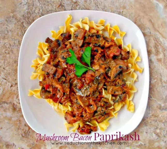 Mushroom Bacon Paprikash is a smokey bacon twist on Paprikash! The savory sweet of the sauce simply makes this dish pop with flavor. Mushroom Bacon Paprikash overhead title