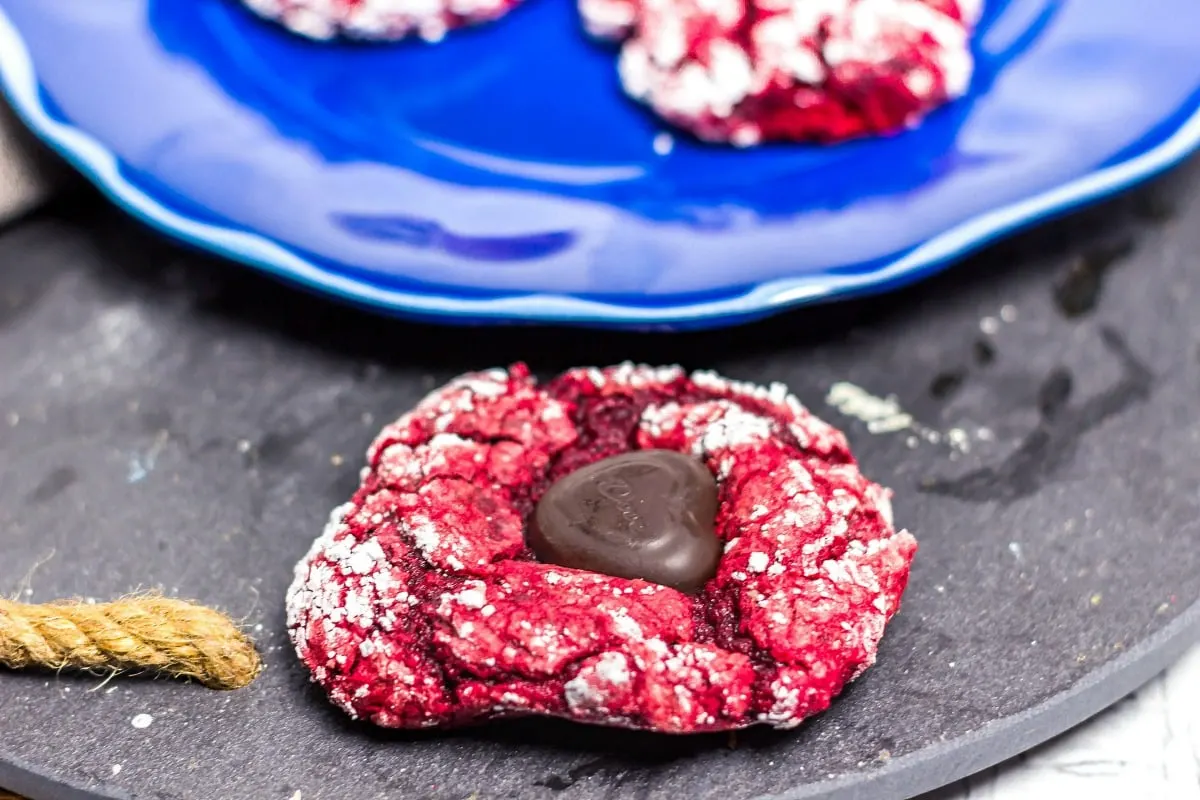 Valentine Red Velvet Cake Mix Blossoms are easy to make and is 5 ingredients! It combines the crinkle cookie with a blossom cookie for a yummy Valentine's Day Treat! Valentine Red Velvet Cake Mix Blossoms close up