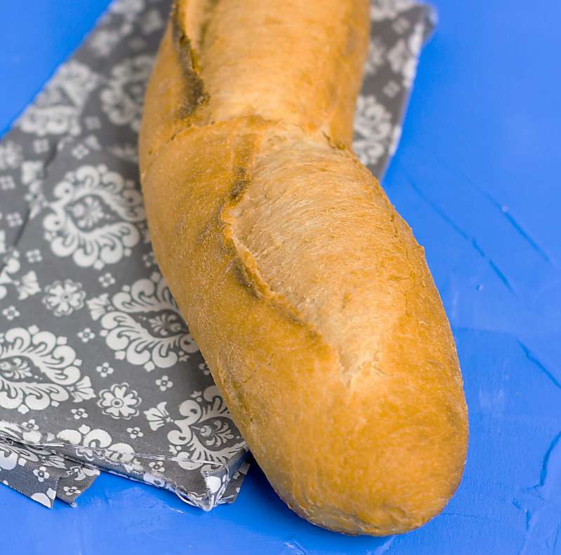French Baguette Bread close up on blue board