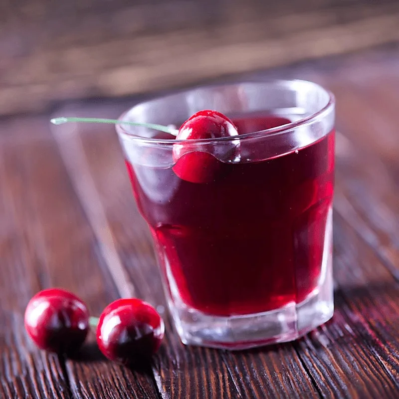 Cherry lime rickey on wood table with cherries