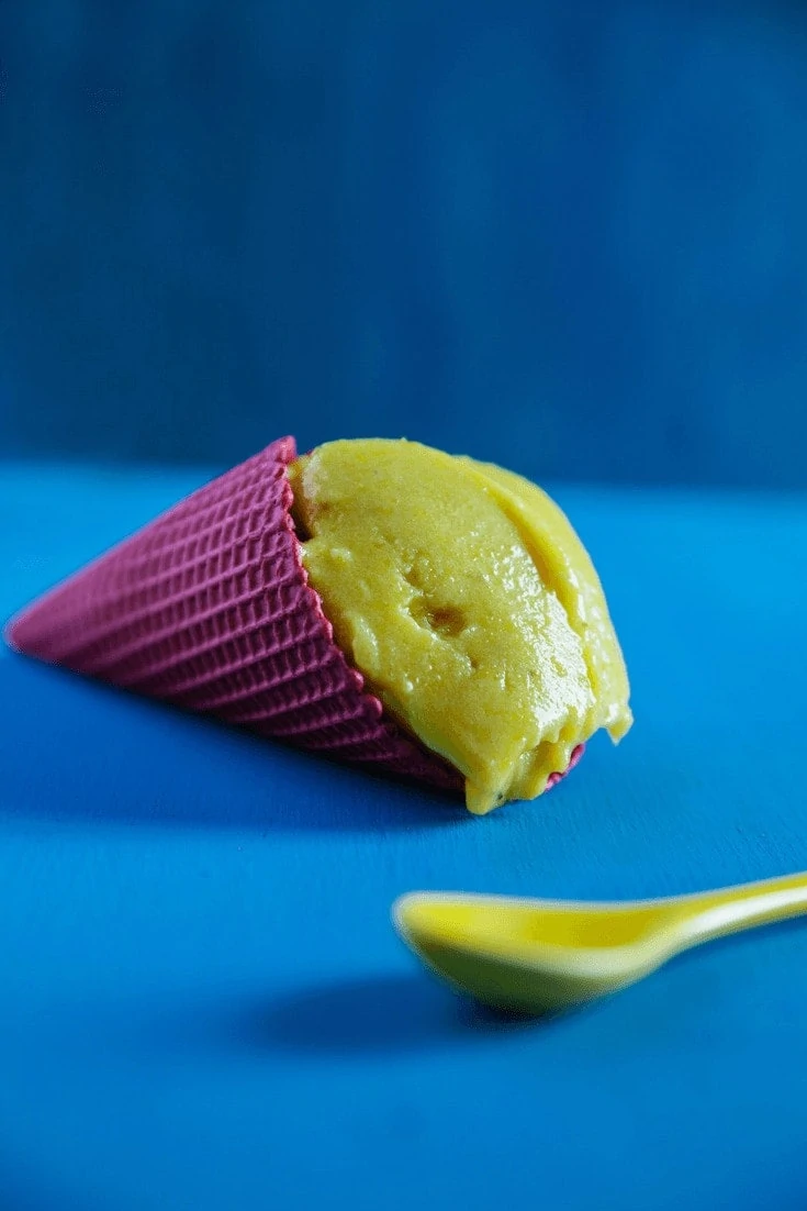 This Green Tea Sorbet is easy to make. Green Tea Sorbet in purple cone on side with green spoon