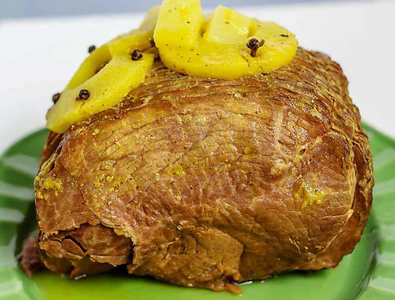 Instant Pot Pineapple Mango ham! It is a simple way to make a holiday ham. Instant Pot Pineapple Mango Ham close up on green plate