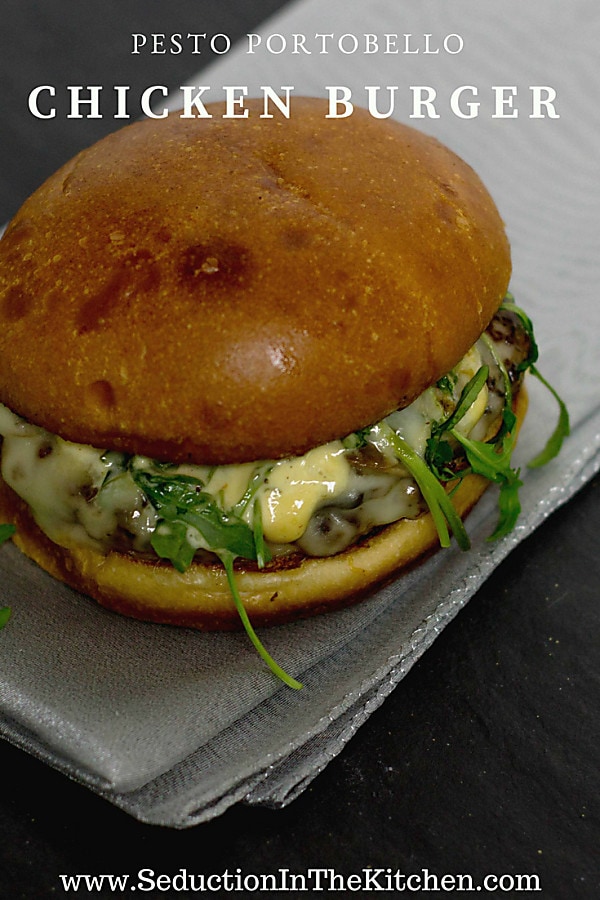 Pesto Portabello Chicken Burger on a silver table cloth on black table title graphic