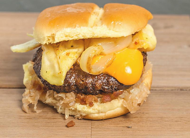 Close up of cheese, saute onions on a burger