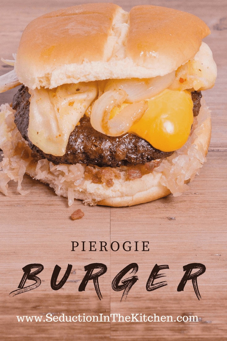 Burger with pirogi, onions and cheese on a cutting board