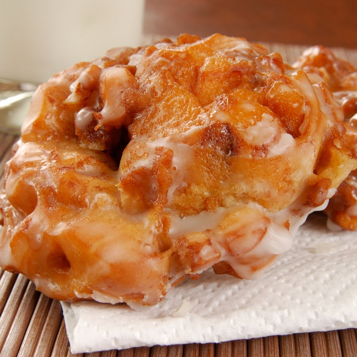Apple Fritters on paper towel, on bamboo placemat