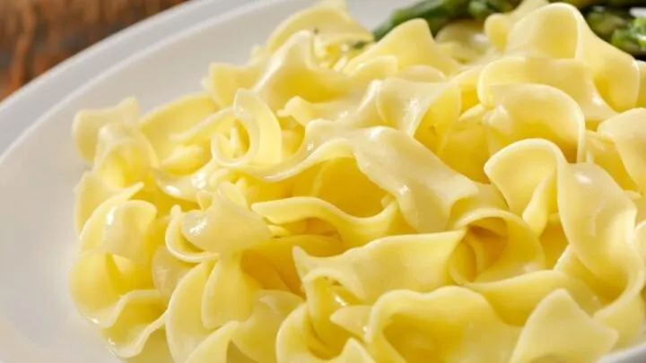 Italian Chicken Flavored Noodles pin on white plate on top of wood table