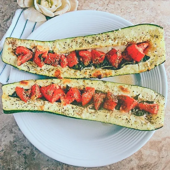 caprese stuffed zucchini on white plate