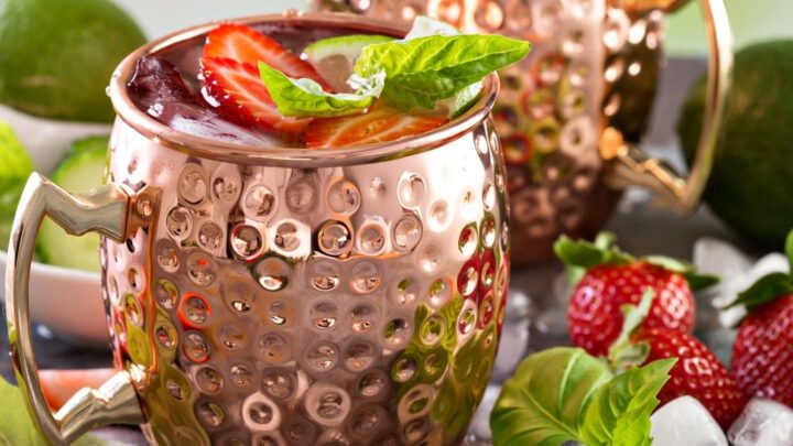 2 Strawberry moscow mules in copper cups and strawberries on top