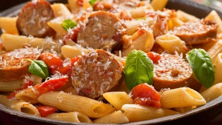 Italian Sausage and Peppers Pasta {Easy Sausage Recipe} Italian Sausage and Peppers Pasta in cast iron skillet on a table
