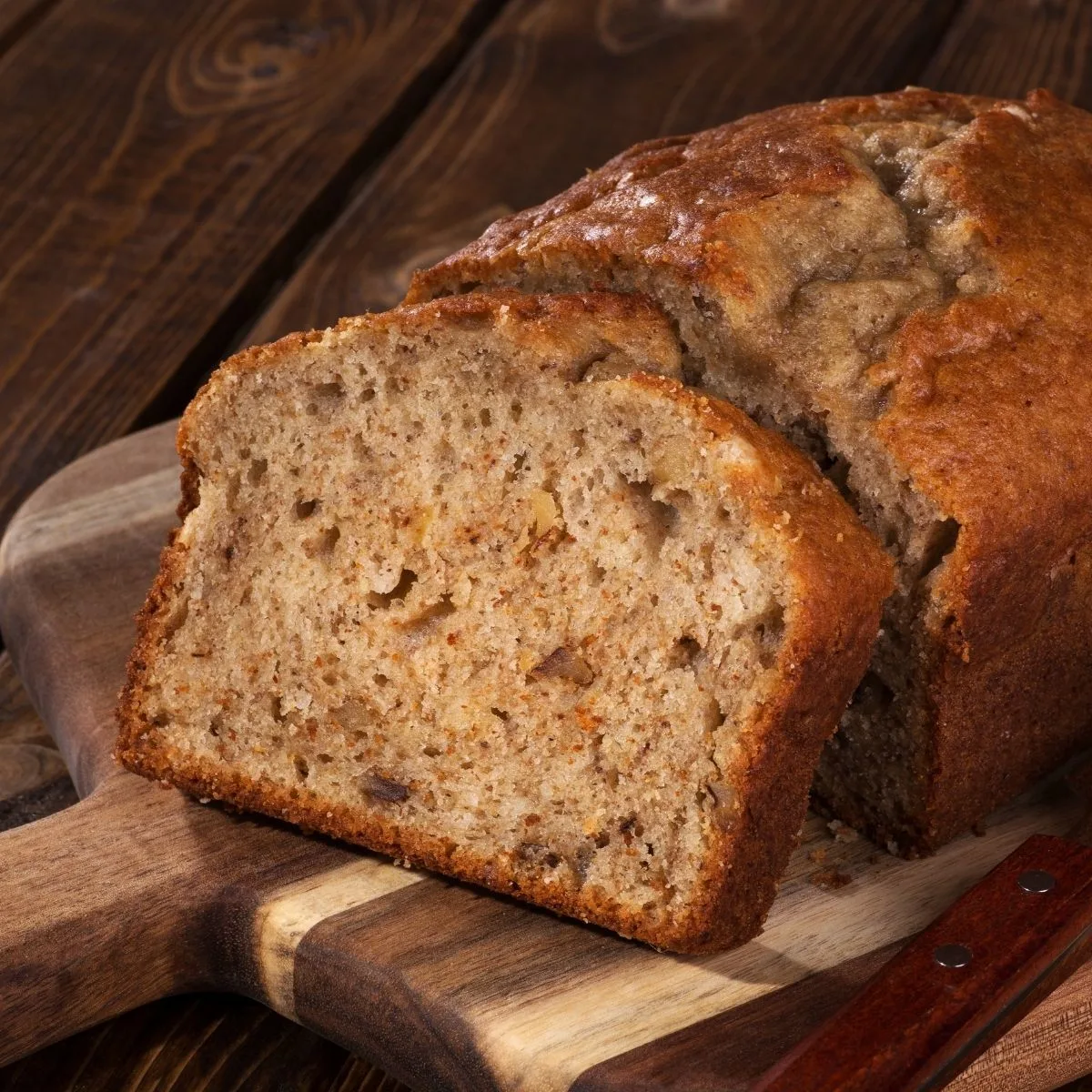 Pear Raisin Bread on wood cutting board on wood table