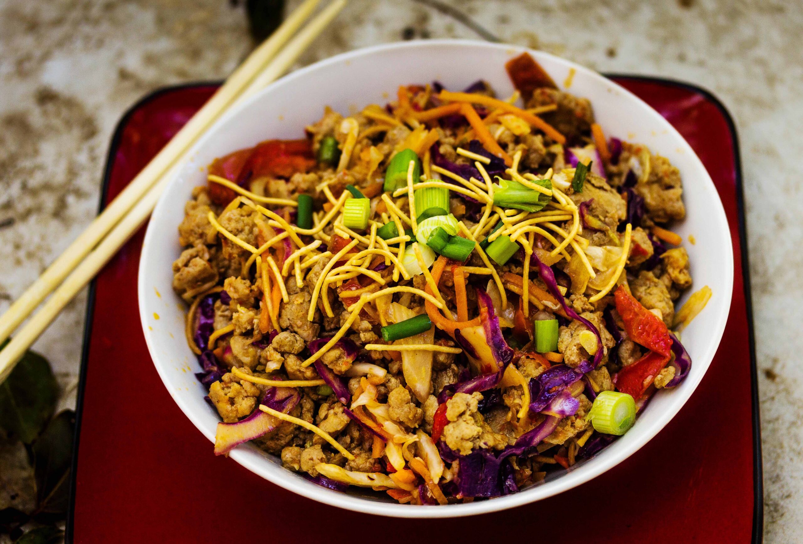 Thai Spring Roll Bowl in white bowl and chopsticks on red plate